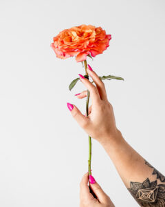 Studio commercial branding image in Winnipeg showing a professional model holding a flower, produced for business marketing, promotional campaigns, and high-end social media and print advertising.