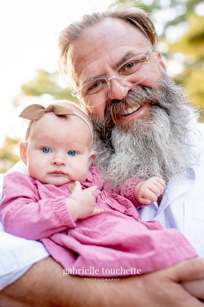 A close-up of a baby and her father at a family portrait photo session in Winnipeg