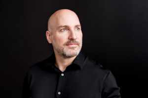 Professional coaching headshot in Winnipeg studio featuring a clean, modern portrait with soft lighting and a confident, approachable style for personal branding and business marketing.