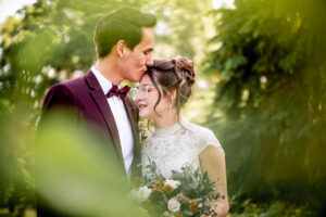 Natural wedding photography in Winnipeg featuring a bride and groom in a summer forest setting, capturing relaxed, timeless and professional outdoor wedding portraits.