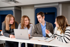 Professional branding photography in Winnipeg for a translation and copywriting business featuring staff collaborating in an office, created as custom imagery for website content, marketing, and authentic social media branding instead of stock photos.