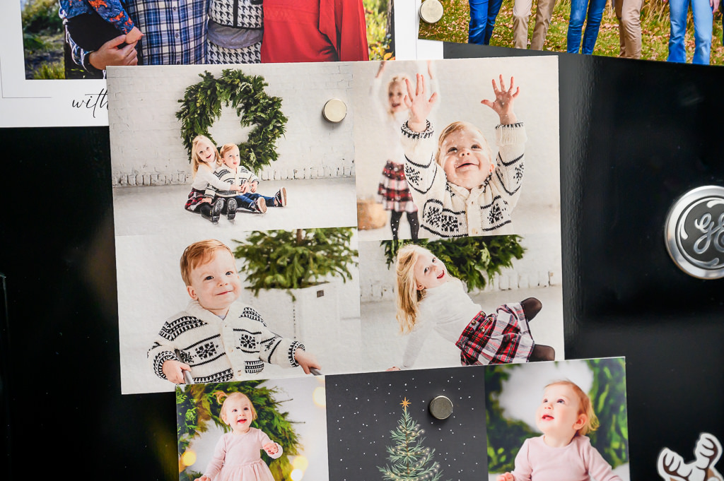 Christmas photo cards displayed on a fridge with magnets