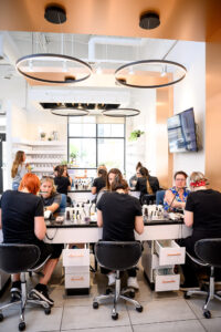 Nail technician working with a client at Almond Nail Bar