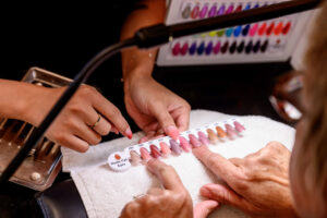 Customer choosing nail polish colours at Almond Nail Bar