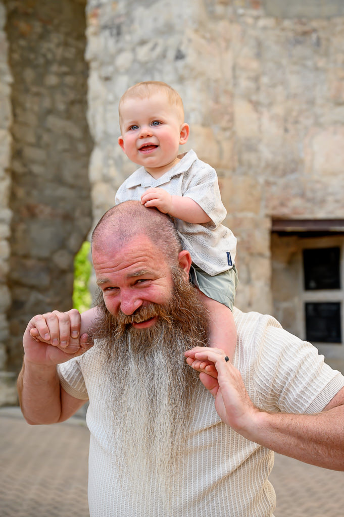 grandson on grandfather's shoulders at candid family photo session in Winnipeg