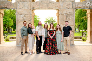 family posing with high school graduate for photo session at St. Boniface Cathedral