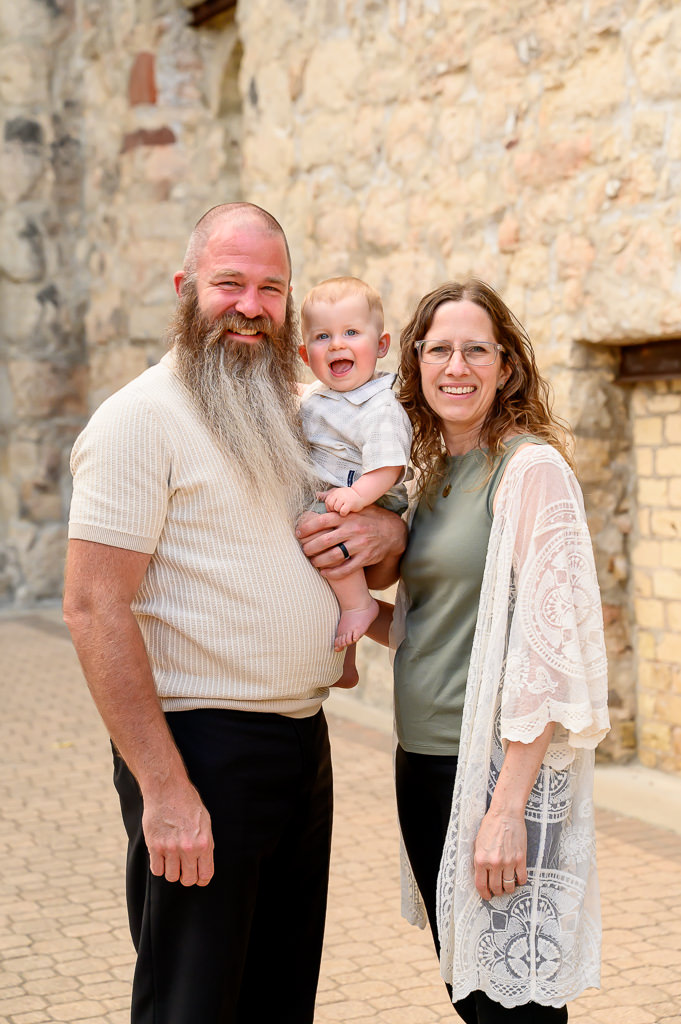 grandparents holding their grandson during family photo session in Winnipeg