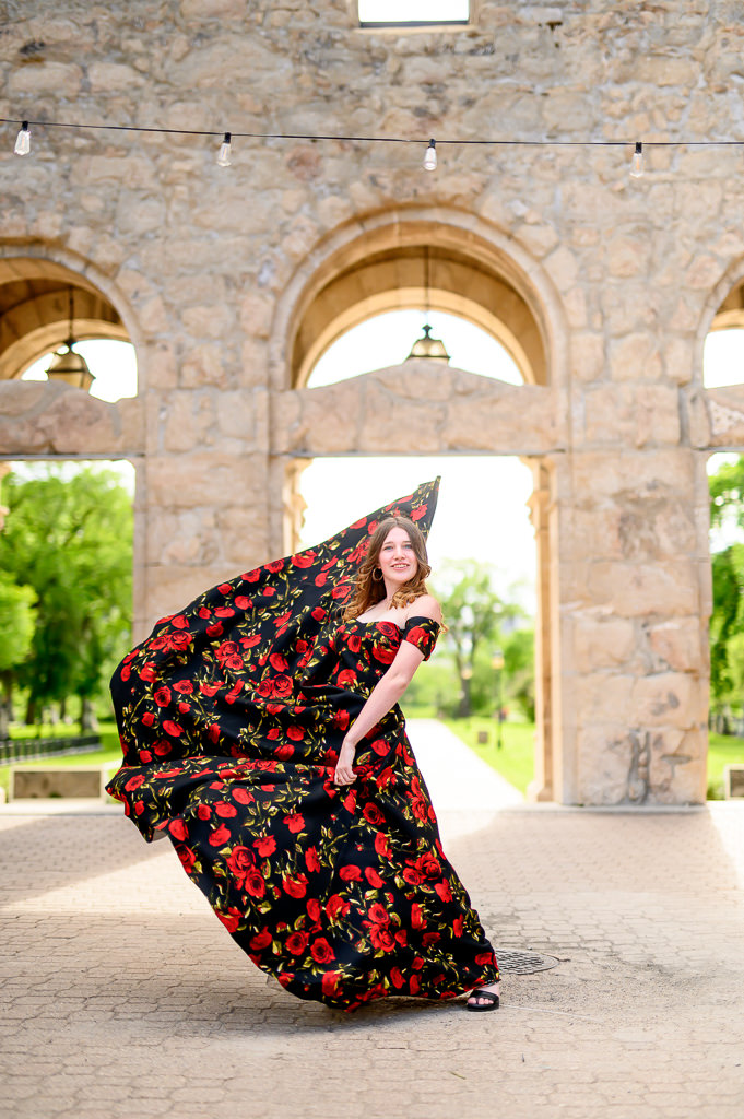 grad photo shoot with dramatic dress, posing at the St. Boniface Cathedral in Winnipeg