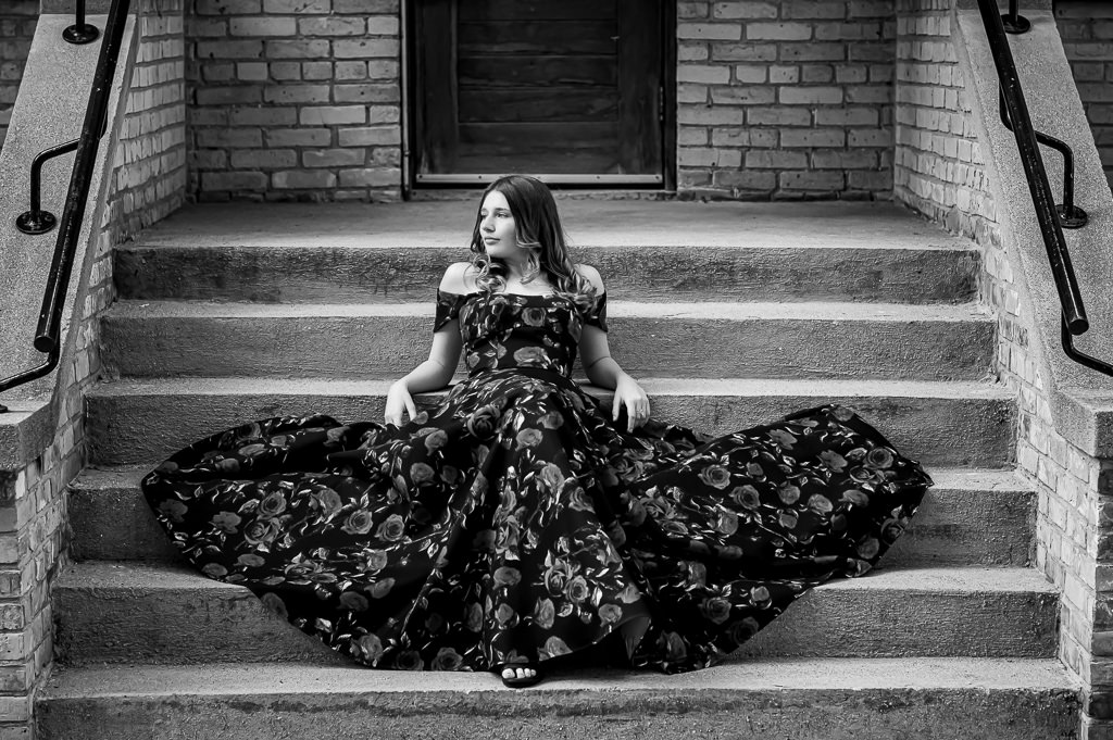 dramatic black and white grad photo shoot on concrete steps in St. Boniface Winnipeg