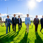 Group of Winnipeg grads getting their photo shoot in the football field at their High School