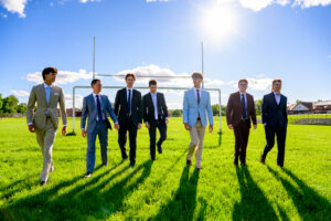 Group of Winnipeg grads getting their photo shoot in the football field at their High School