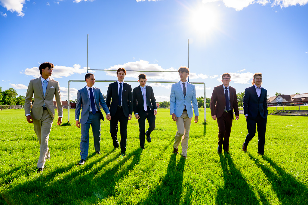 Group of Winnipeg grads getting their photo shoot in the football field at their High School