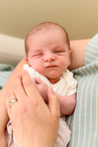 a cute little newborn sleeping photo, peacefully in her mom's arms