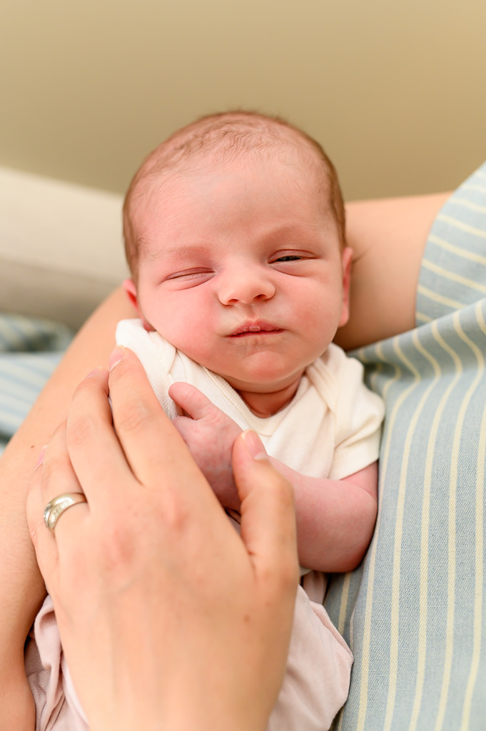 a cute little newborn sleeping photo, peacefully in her mom's arms