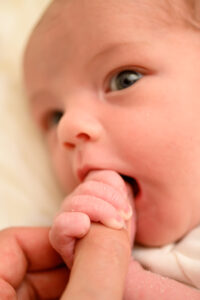 a close up photo of a newborn baby with her eyes open