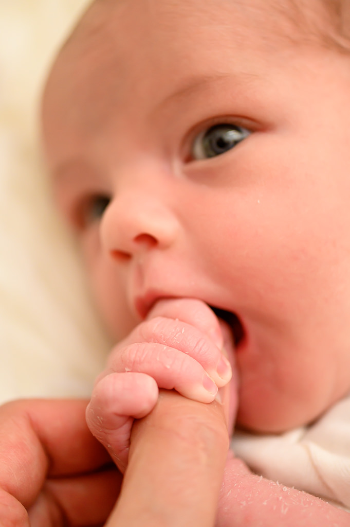 a close up photo of a newborn baby with her eyes open