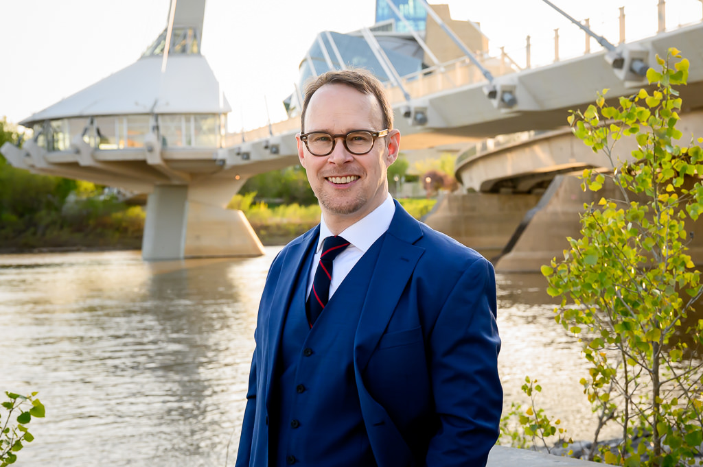 Professional headshots in Winnipeg in a natural outdoor setting against the city skyline.