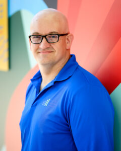 Professional headshot with colourful architecture in Winnipeg