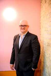 Professional headshot of a Winnipeg business owner at The Forks