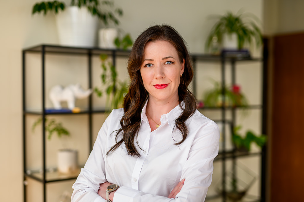 Professional headshot photography in Winnipeg, using a natural background in the office.