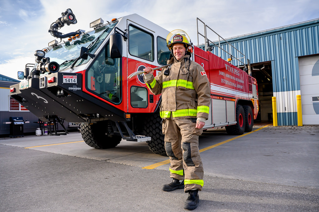 Winnipeg Airports Authority photography session featuring a firetruck and firefighter.