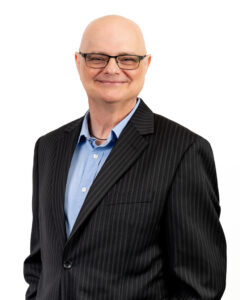Studio-lit corporate headshot with white backdrop