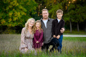 Family portrait surrounded by trees at Birds Hill Park