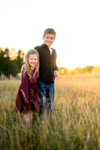 Children smiling during an outdoor family photography session